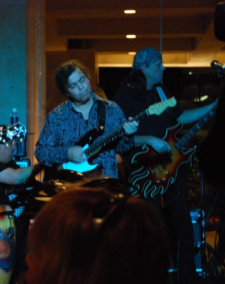 A Group Of Men Playing Guitars